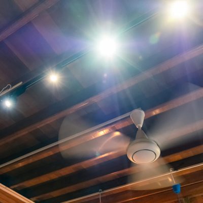 Ancient rotation fan on wood ceiling with light shining decorati Ancient rotation fan on wood ceiling with light shining decoration at home